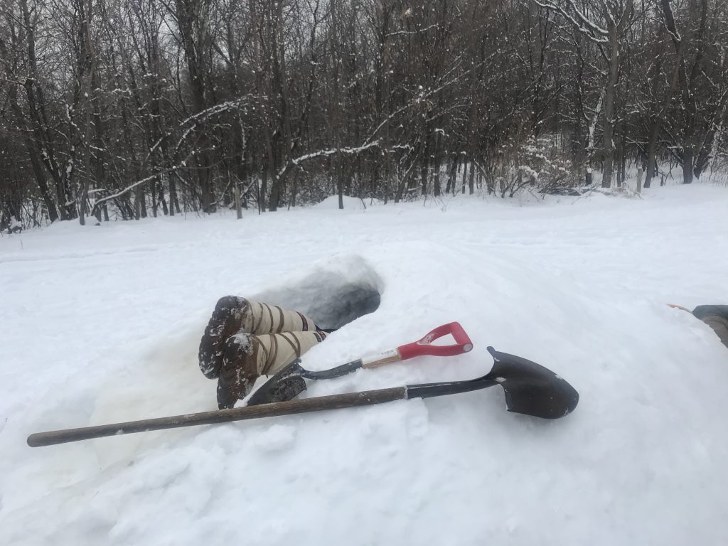 Dodge Nature Center Naturalist Fellow Siri Block excavates a snow tunnel.