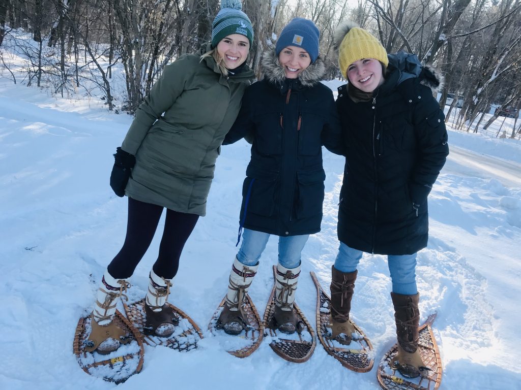 Julia Pedersen, left, Siri Block and Rachel Vortherms test out snowshoes on Dodge's snowy trails.
