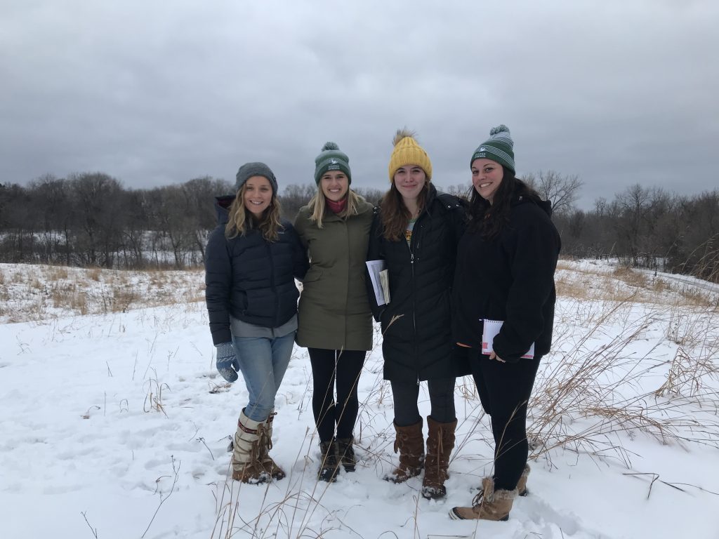 Dodge Nature Center's 2019-2020 class of Naturalist Fellows in the prairie on the Main Property in West St. Paul.