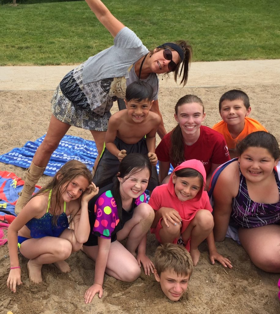 Dodge Nature Center Naturalist Pam Welisevich and her Fish and Swim campers on the beach.