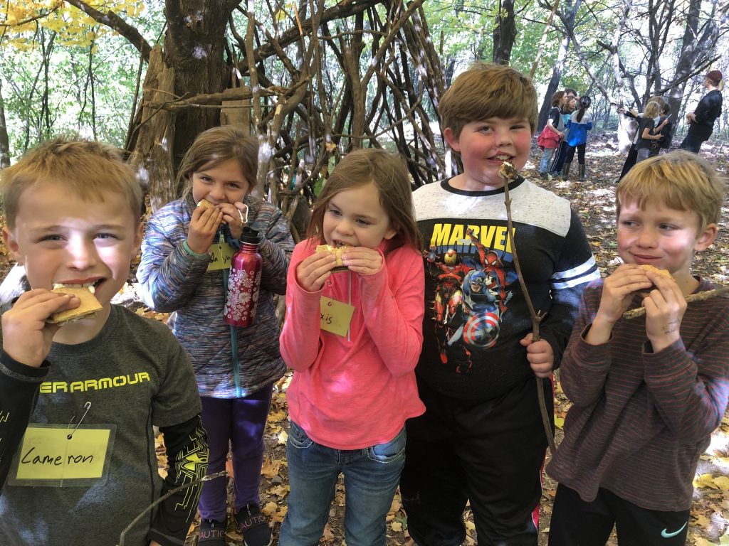 Dodge Nature Center campers dig into their fire-roasted sweet treats, s'mores!