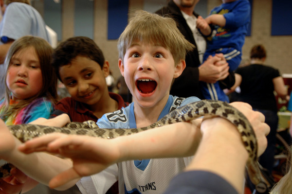An excited kid holds one of Dodge Nature Center's snakes.