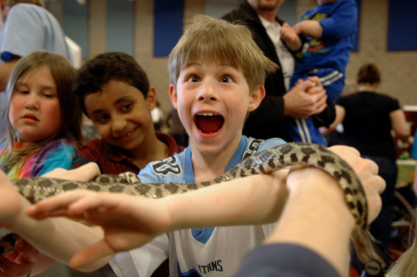 An excited kid holds one of Dodge Nature Center's snakes.